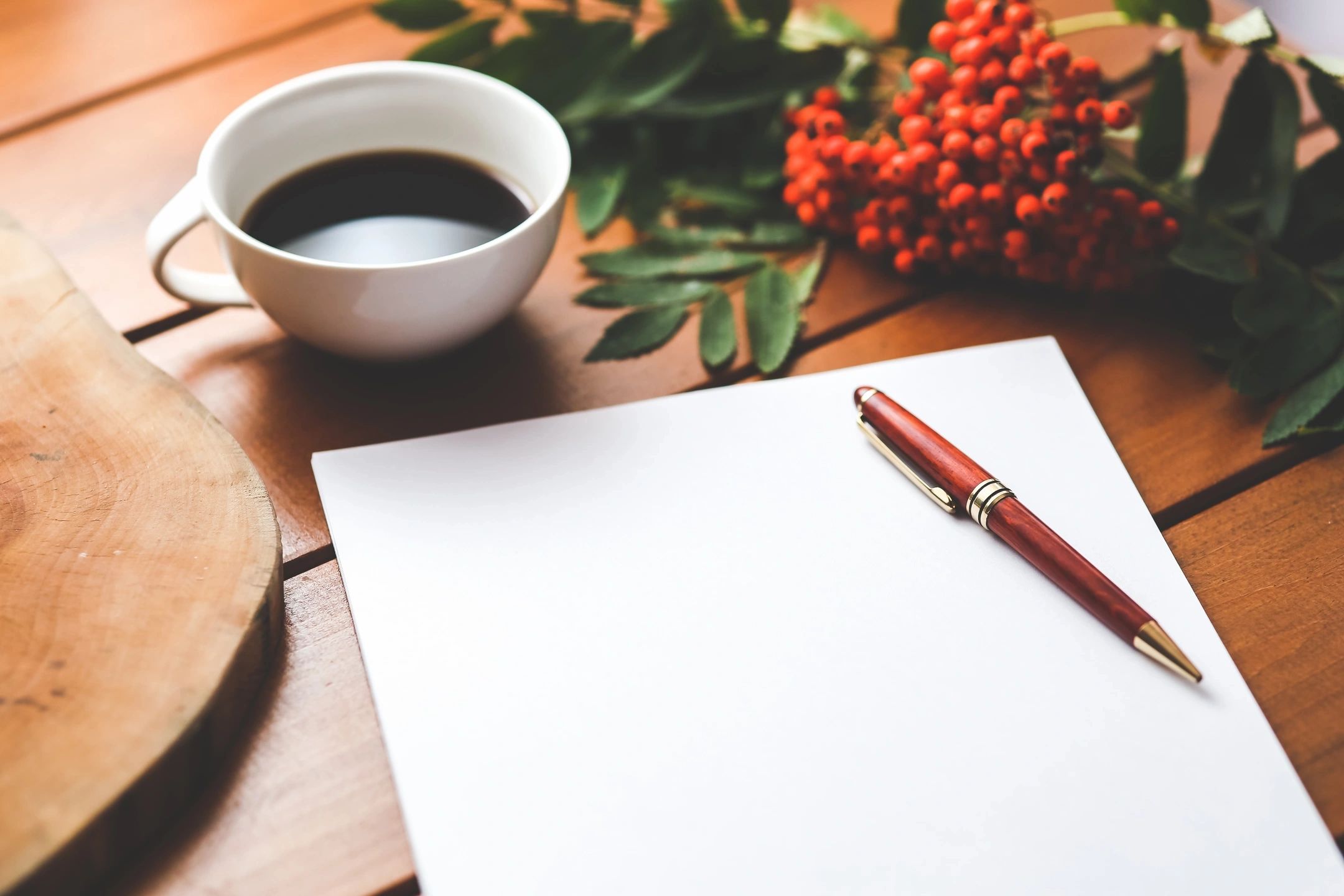 A pen and paper on top of a table.